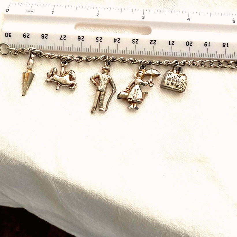 Vintage 1960s Disney Mary Poppins charm bracelet original collectible with umbrella, carousel horse, Bert, Mary, and carpet bag.